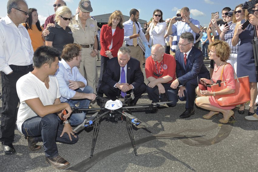 Gov. Terry Mc Auliffe and Virginia Tech President Timothy D. Sands inspect a Flirtey hexacopter before its flight carrying medicines from the Lonesome Pine Airport to the Wise County Fairgrounds on Friday