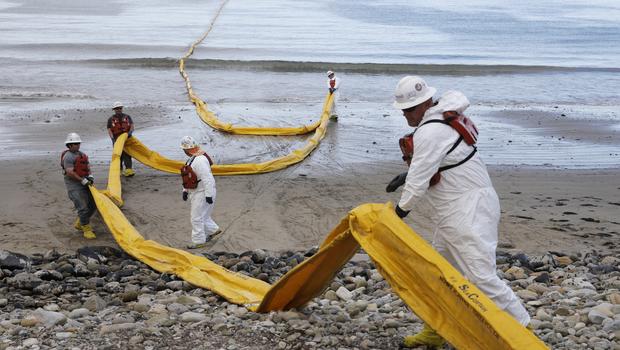 Workers prepare an oil containment boom at Refugio State Beach north of Goleta Calif. Thursday