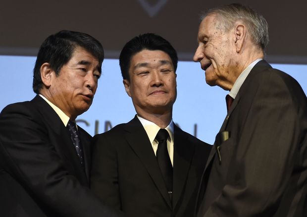 American World War II prisoner of war James Murphy shakes hand with Hikaru Kimura, Mitsubishi Materials Corp. senior executive and Yukio Okamoto