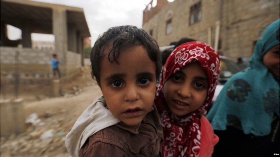 Yemeni children wait for food packages delivered by volunteers to poor family during the Muslims fasting month of Ramadan at a slum in Sana'a Yemen 29 June 2015