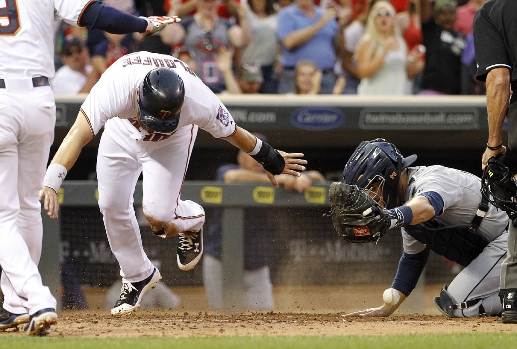 Minnesota Twins&#39 Trevor Plouffe scores from second base as Detroit Tigers catcher Alex Avila drops the errant throw from Tigers third baseman Nick Castellanos during the fifth inning Thursday