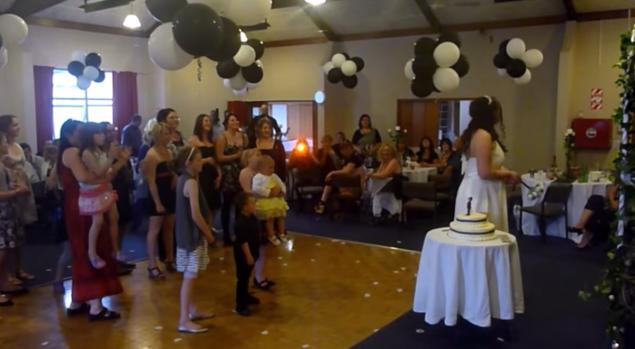 A woman was seen in an online video dropping a young child so she could try to catch the wedding bouquet