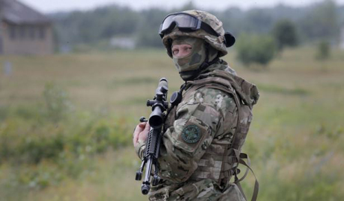 A Ukrainian soldier stands during training in a landfill at Chuguev Ukraine