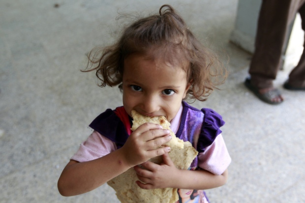 A Yemeni child gets a rare meal after her family fled fighting All sides in the conflict must approve aid for it to be viable