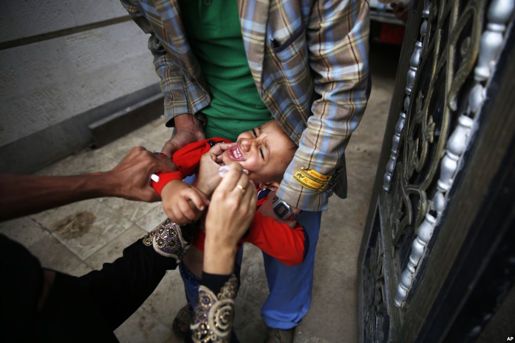 A boy receives a polio vaccination during a polio immunization campaign in Sana'a Yemen