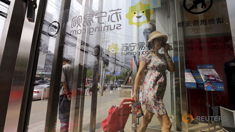 A customer walks into a Suning appliance store in Beijing