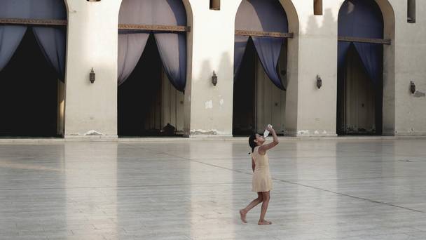 A girl cools off at the Al Hakim bi-Amr Allah Mosque in Cairo