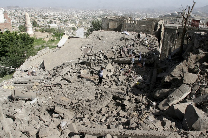 A man walks on the rubble of houses destroyed by Saudiled air strikes in Yemen's central city of Taez pic