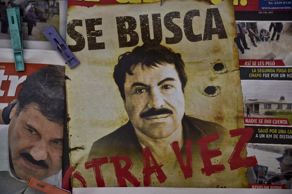 A poster with the face of Mexican drug lord Joaquin “El Chapo” Guzman reading “Wanted Again”