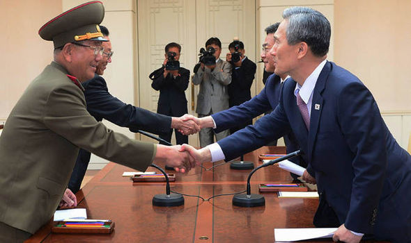 South Korean presidential security adviser Kim Kwan-jin right and Unification Minister Hong Yong-pyo second right shake hands with Hwang Pyong So