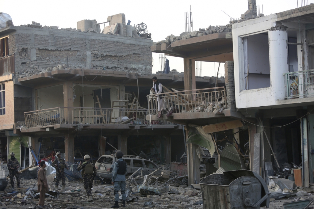 ASSOCIATED PRESS			Afghan security personnel inspect at the site of a car bomb attack in Kabul Afghanistan Friday Aug. 7 2015