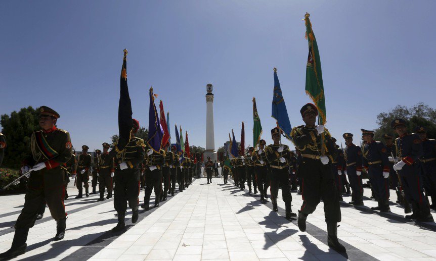 Afghan honor guards stand next to the minaret of liberty during Afghan Independence Day celebration in Kabul