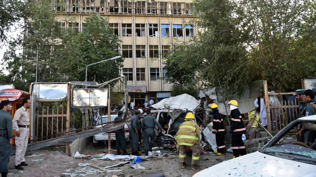 Afghan police and security forces inspect the site of a car bomb in Kabul on Aug. 22 2015