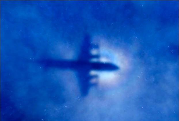 The shadow of a Royal New Zealand Air Force P3 Orion maritime search aircraft seen on low-level clouds as it flies over the southern Indian Ocean looking for missing Malaysia Airlines Flight MH370