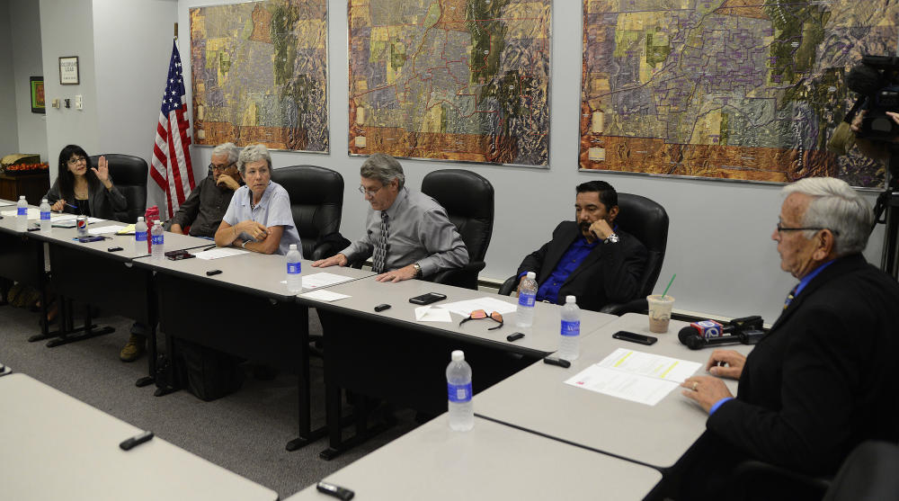 Albuquerque Public School Board of Education member Peggy Muller-Aragon left speaks to Board President Don Duran right after Duran announced that the board was going into an executive session to discuss the future of Superintendent Luis Valentino on S