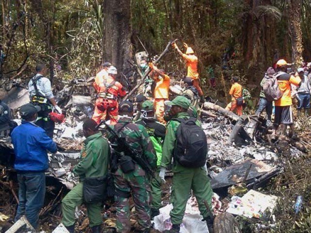 Indonesian rescuers search through the wreckage of the Trigana Air ATR 42-300 twin-turboprop plane at the crash site in the mountainous area of Ogbape near Oksibil district located in Papua province