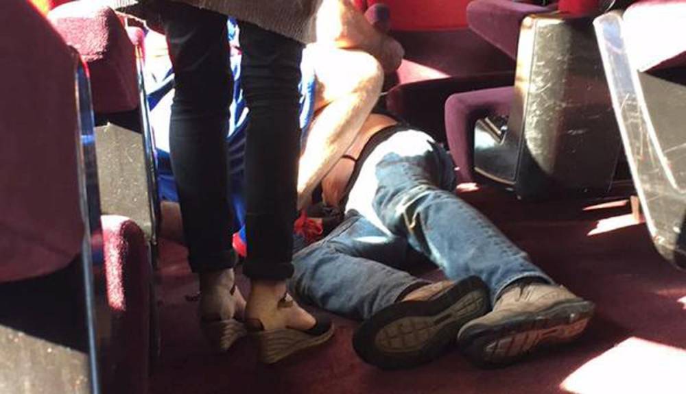 A man lies on the on floor in the Amsterdam to Paris Thalys highspeed train where shots were fired and several people were injured according to the French interior ministry in Arras France