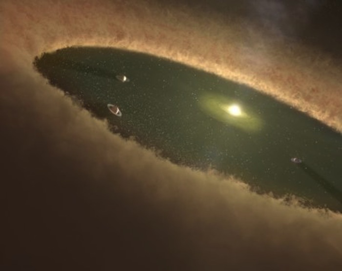 An artist’s concept of a young star system shows gas giants forming first while the gas nebula is present