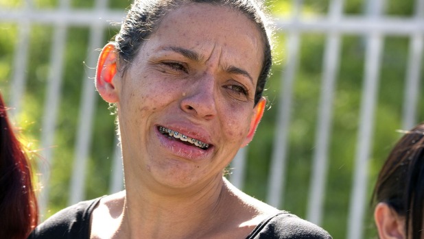 Angela Pereira de Souza whose husband was shot dead in a bar cries outside a police station in Osasco Brazil on Friday