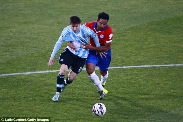 Argentina forward Lionel Messi tussles for possession with Chile's Jean Beausejour