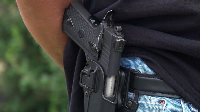 Armed citizens stand guard at recruiting center following Tennessee shootings.                      WEWS