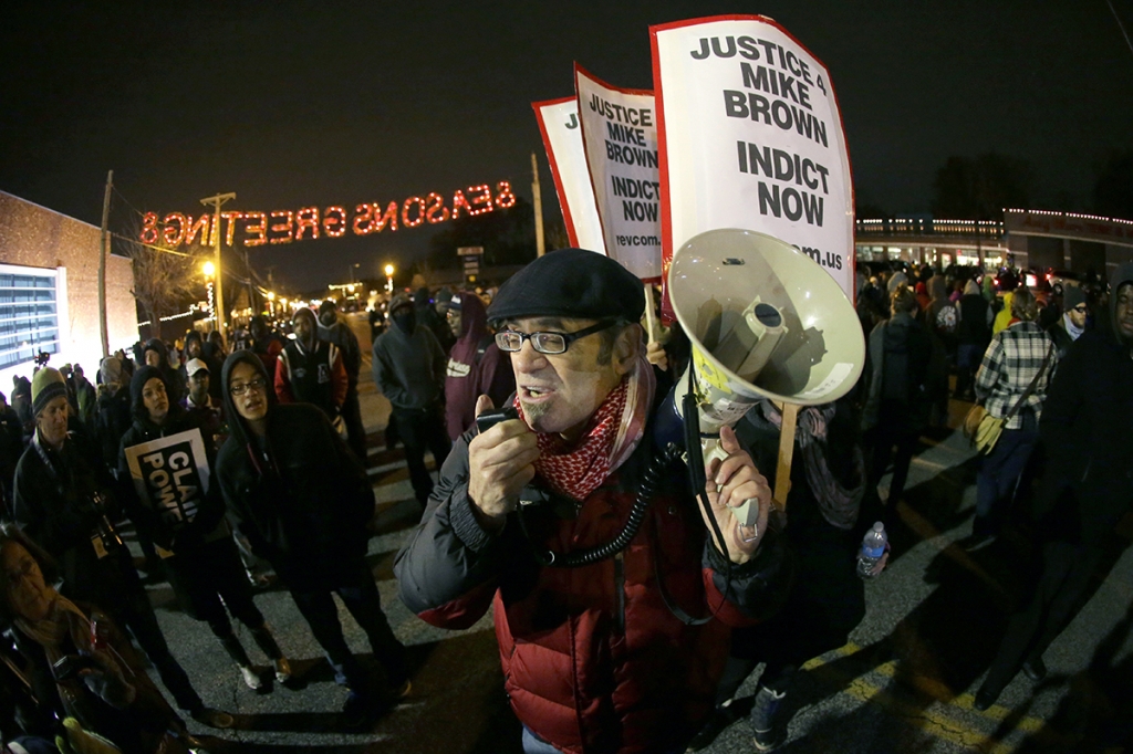 Protesters gather in front of the Ferguson Police Department before the announcement of the grand jury decision about whether to indict a Ferguson police officer in the shooting death of Michael Brown