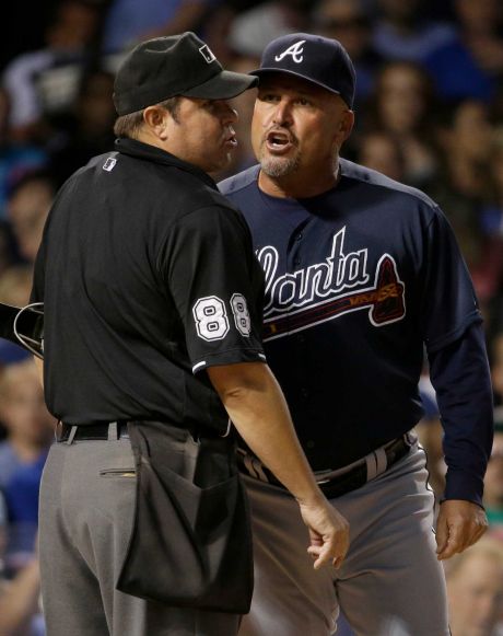 Atlanta Braves manager Fredi Gonzalez right argues with home plate umpire Doug Eddings during the third inning of a baseball game against the Chicago Cubs Thursday Aug. 20 2015 in Chicago. Gonzalez ejected by Eddings