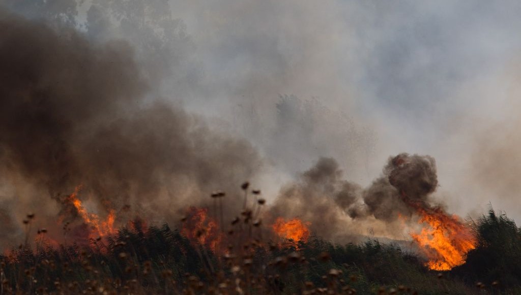 A large brush fire raging outside Kfar Sold in the Golan Heights sparked by four missiles fired from the Syrian side of the Israeli Syrian border