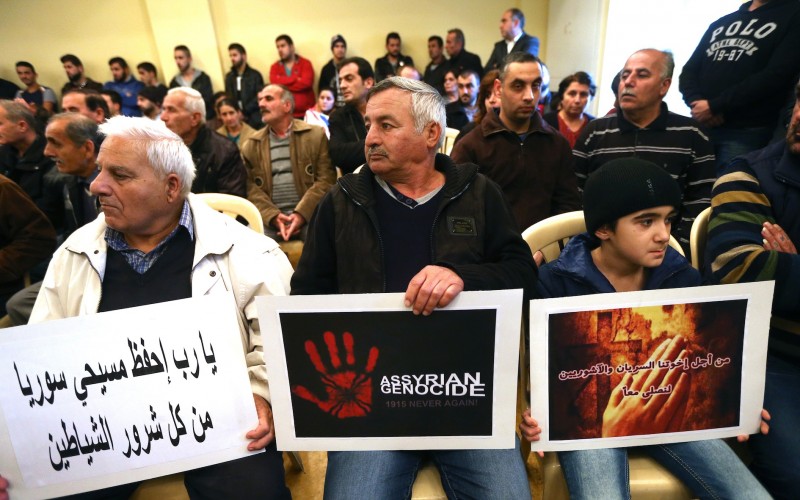 Assyrians citizens hold placards during a sit-in for abducted Christians in Syria and Iraq at a church in Lebanon