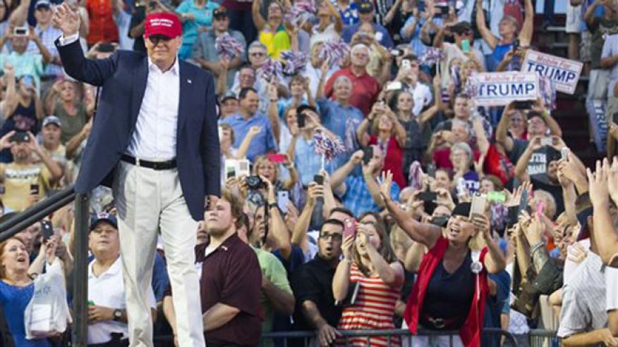 Republican presidential candidate Donald Trump waves to supporters during a campaign rally in Mobile Ala