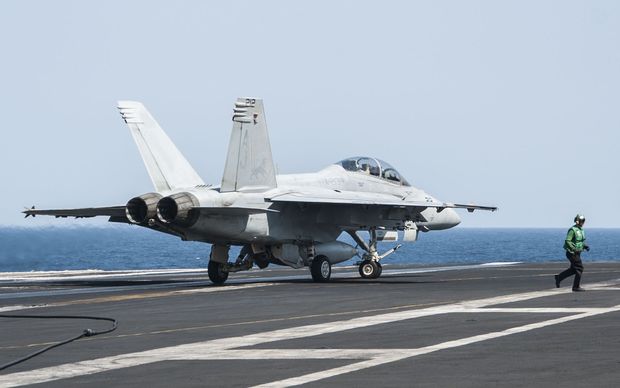A United States F A18F Super Hornet lands on aircraft carrier USS George HW Bush after carrying out strikes on IS targets
