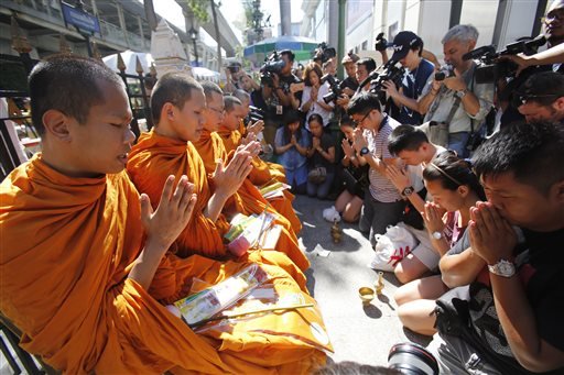 The central Bangkok shrine reopened to the public after's bomb blast as authorities searched for a man seen in