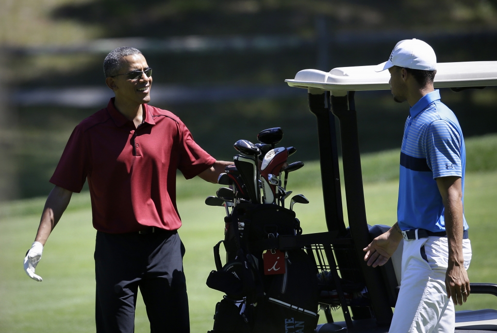 President Barack Obama speaks with NBA basketball player Stephen Curry of the Golden State Warriors while golfing Friday Aug. 14 2015 at Farm Neck Golf Club in Oak Bluffs Mass. on the island of Martha's Vineyard. The president first lady Michell