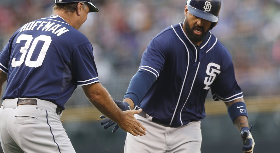 San Diego Padres third base coach Glenn Hoffman left congratulates Matt Kemp as he circles the bases after hitting a two-run home run off Colorado Rockies starting pitcher Yohan Flande in the first inning of a baseball game Friday Aug. 14 2015 in Den