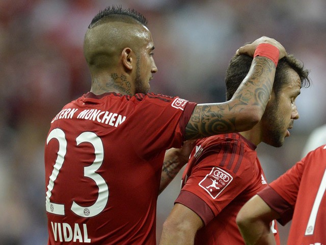 Bayern Munich's Spanish defender Juan Bernat celebrates scoring with Chilean midfielder Arturo Vidal during the Audi Cup football match FC Bayern Munich vs AC Milan in Munich southern Germany