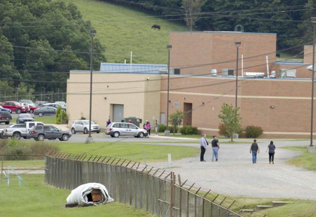 Parents are seen walking to meet up with their children after the evacuation