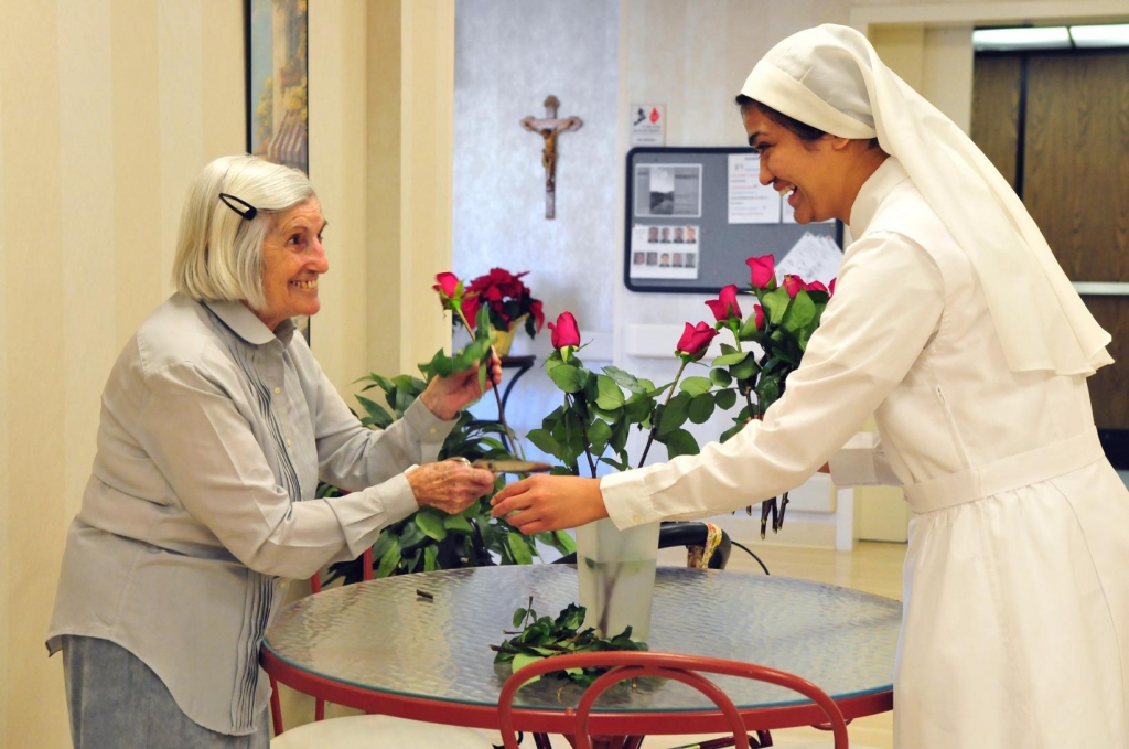 A resident and a sister arrange flowers at the Little Sisters of the Poors Mullen Home in Denver in this undated file