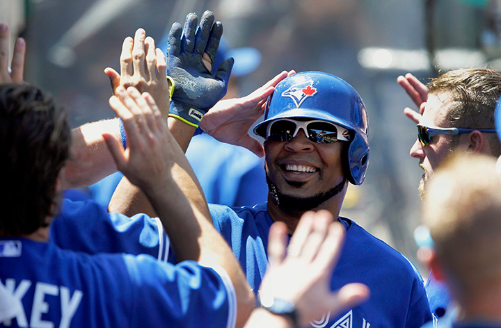 Toronto Blue Jays’ Edwin Encarnacion is congratulated by teammates after scoring against the Los Angeles Angels in Anaheim Calif. Sunday Aug. 23 2015