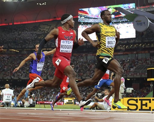 Jamaica's Usain Bolt right an United States Mike Rodgers run in a mens round one heat of the 100m at the World Athletic Championships at Bird's Nest stadium in Beijing