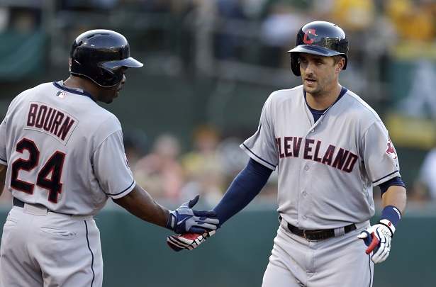 Cleveland Indians Lonnie Chisenhall right is congratulated by Michael Bourn after hitting a home run off Oakland Athletics Aaron Brooks in the fifth inning of a baseball game Saturday Aug. 1 2015 in Oakland Calif