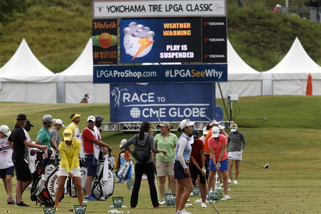 Competitors warm up as play is set to resume after being suspended for more than five hours during the third round of the Yokohoma Tire LPGA Classic golf tournament at Robert Trent Jones Golf Trail at Capitol Hill Saturday Aug. 29 2015 in Prattville