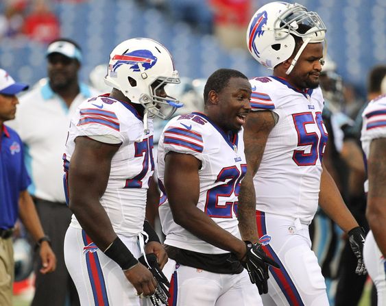 Buffalo Bills linebacker Ikemefuna Enemkpali left running back Le Sean McCoy and Cedric Reed walk on the field before an NFL preseason football game against the Carolina Panthers in Orcha