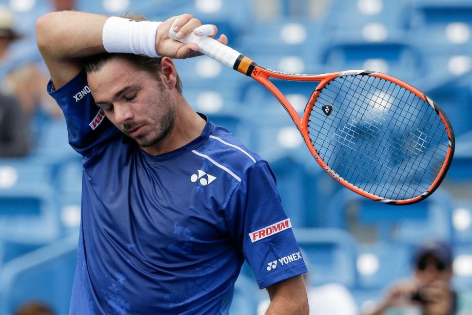 Stanislas Wawrinka of Switzerland wipes sweat from his forehead during his match against Borna Coric of Croatia at the Western & Southern Open tennis tournament Wednesday Aug. 19 2015 in Mason Ohio