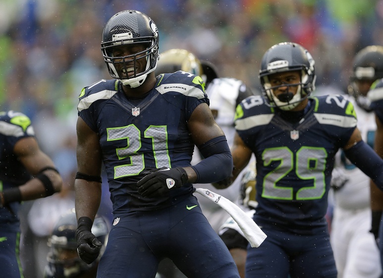 Seattle Seahawks&#039 Kam Chancellor celebrates a play against the Jacksonville Jaguars along with teammate Earl Thomas in the first half of an NFL football game