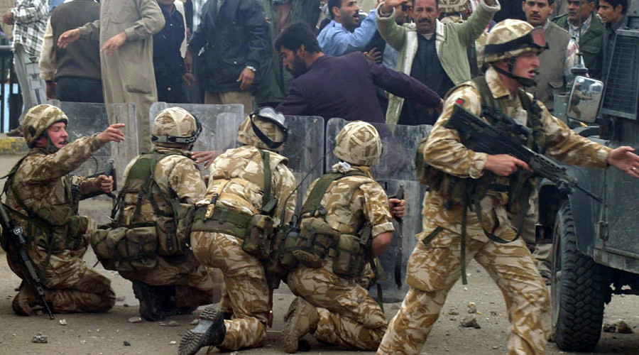 British Army troops take position near a crowd of protesting former Iraqi soldiers after stones were thrown in the southern Iraq city of Basra in this