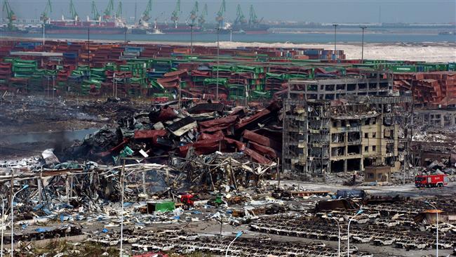 Mangled cargo containers and twisted wreckage at the site of the explosions in Tianjin