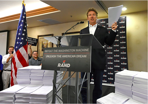 LAS VEGAS NV- JUNE 29 Republican presidential candidate U.S. Sen. Rand Paul is flanked by more than 74,000 pieces of paper representing the size of the U.S. tax code as he speaks during a campaign stop at an Embassy Suites hotel