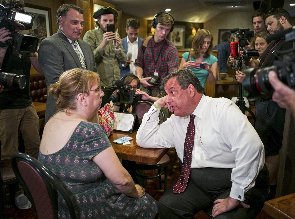 Chris Christie Governor of New Jersey and candidate in the Republicans presidential candidates race talks with a voter at The Puritan Backroom in Manchester N.H. on Aug. 3 2015