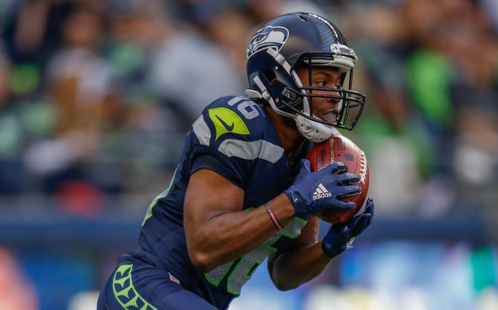 SEATTLE WA- AUGUST 14 Kick returner Tyler Lockett #16 of the Seattle Seahawks returns a kickoff for a touchdown against the Denver Broncos at Century Link Field