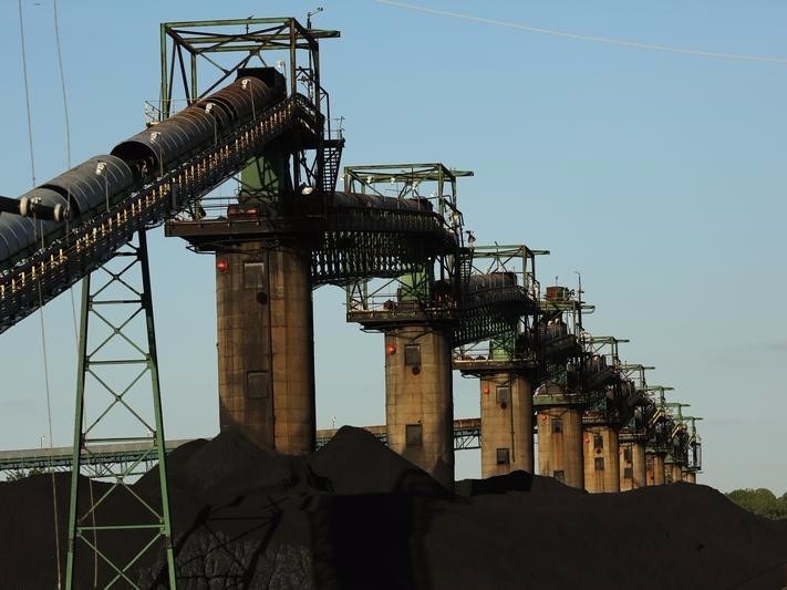 Coal is stacked at the base of coal loaders along the Ohio River in Ceredo